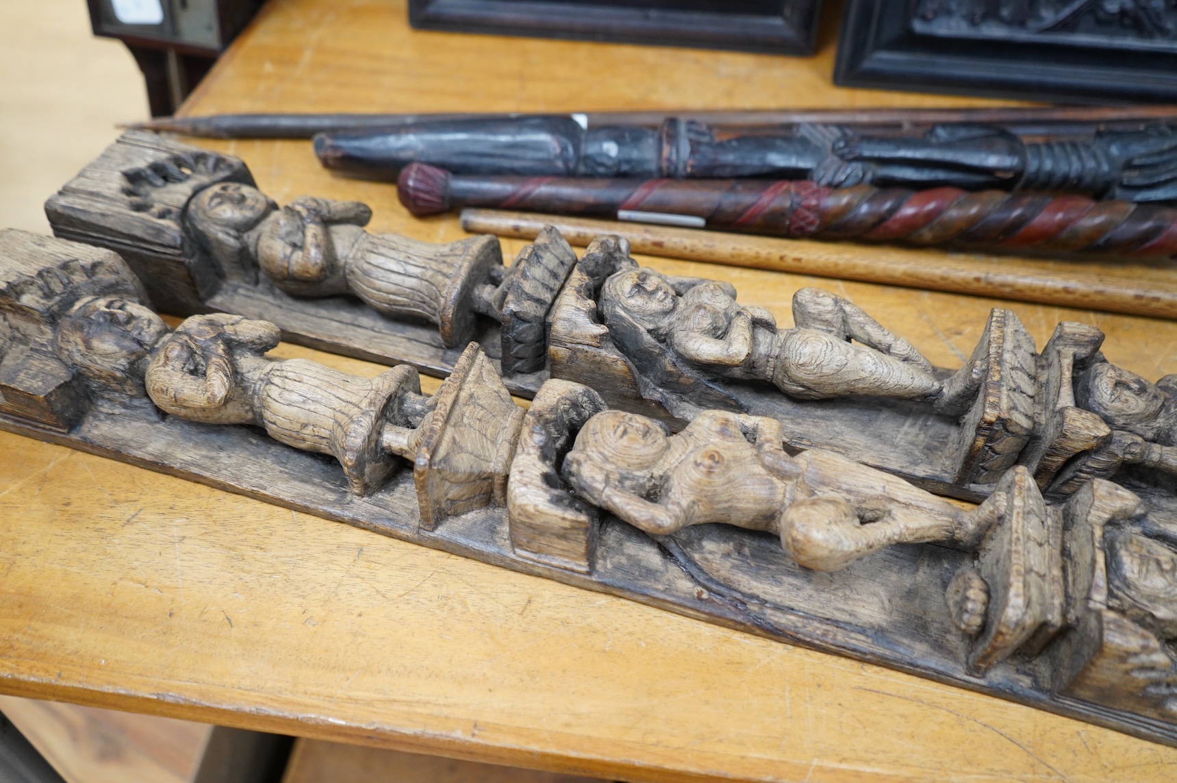 A pair of 19th century Indian carved wood figural pilasters - 74cm long